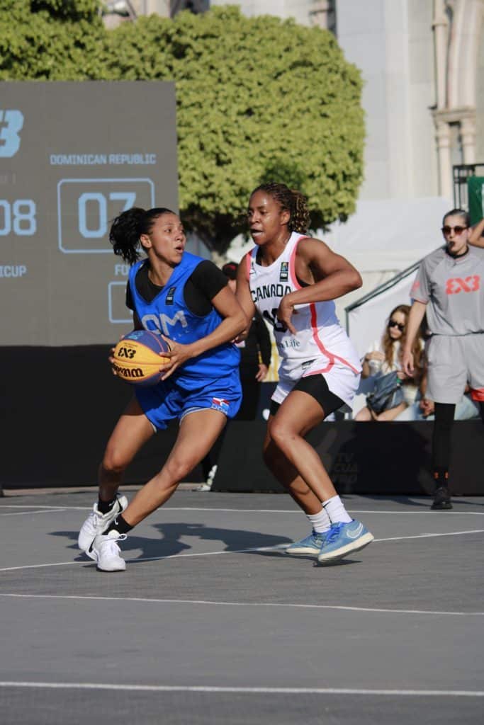 1. Atletas femeninas jugando baloncesto en cancha callejera en torneo internacional.