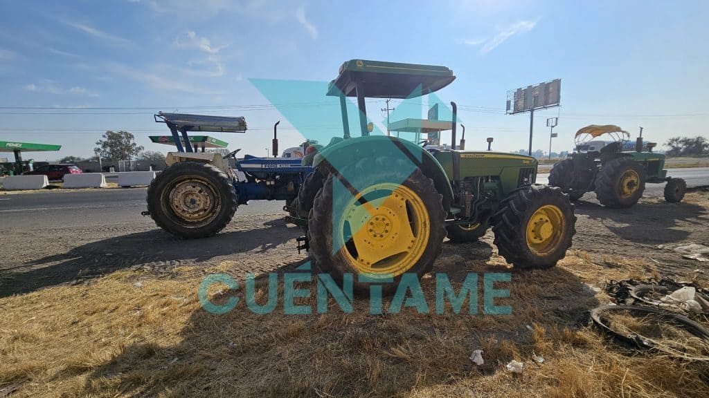 Tractores agrícolas estacionados en la orilla de la carretera durante el día.