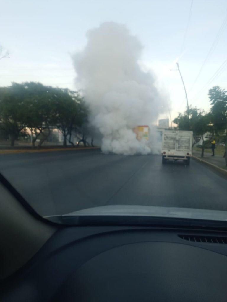 Camioneta de botanas se incendia por presunta falla mecánica en León Lámpara de gas en llamas en una calle con árboles y tráfico en Ciudad de México.